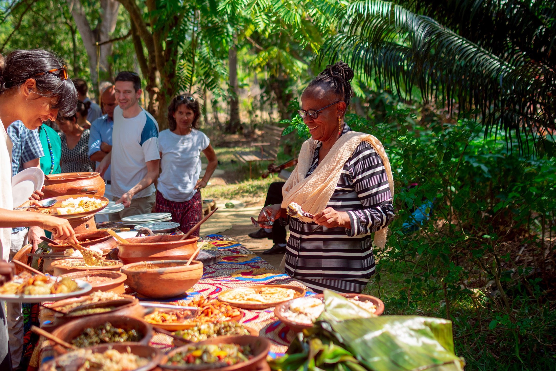 Farmer Mwatima Juma serves up food for tourists at a buffet on her Msonge Farm in Zanzibar. (Keegan Checks via dpa)