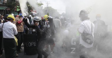 Anti-coup protesters discharge fire extinguishers to counter the impact of the tear gas fired by police during a demonstration in Mandalay, Myanmar, March 7, 2021. (AP Photo)