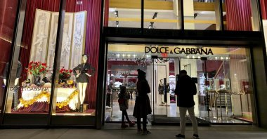 People stand outside the Dolce &amp; Gabbana store on Fifth Avenue, in New York City, U.S., Nov. 21, 2021. (AP Photo)