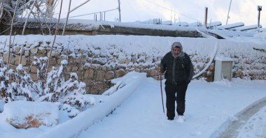 A man walks through a snow-covered road in Lebanon's historic city of Baalbek in the eastern Bekaa Valley, Jan. 27, 2022. (AFP Photo)