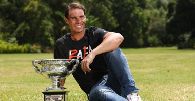 Spain's Rafael Nadal poses with the winner's trophy the morning after his victory in the Australian Open men's singles final, Melbourne, Australia, Jan. 31, 2022. (AFP Photo)