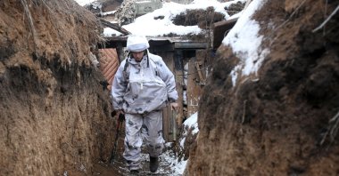 A Ukrainian serviceman walks along a snow-covered trench on the frontline with the Russia-backed separatists near Verkhnetoretskoye village, in the Donetsk region, Feb. 1, 2022. (AFP Photo)