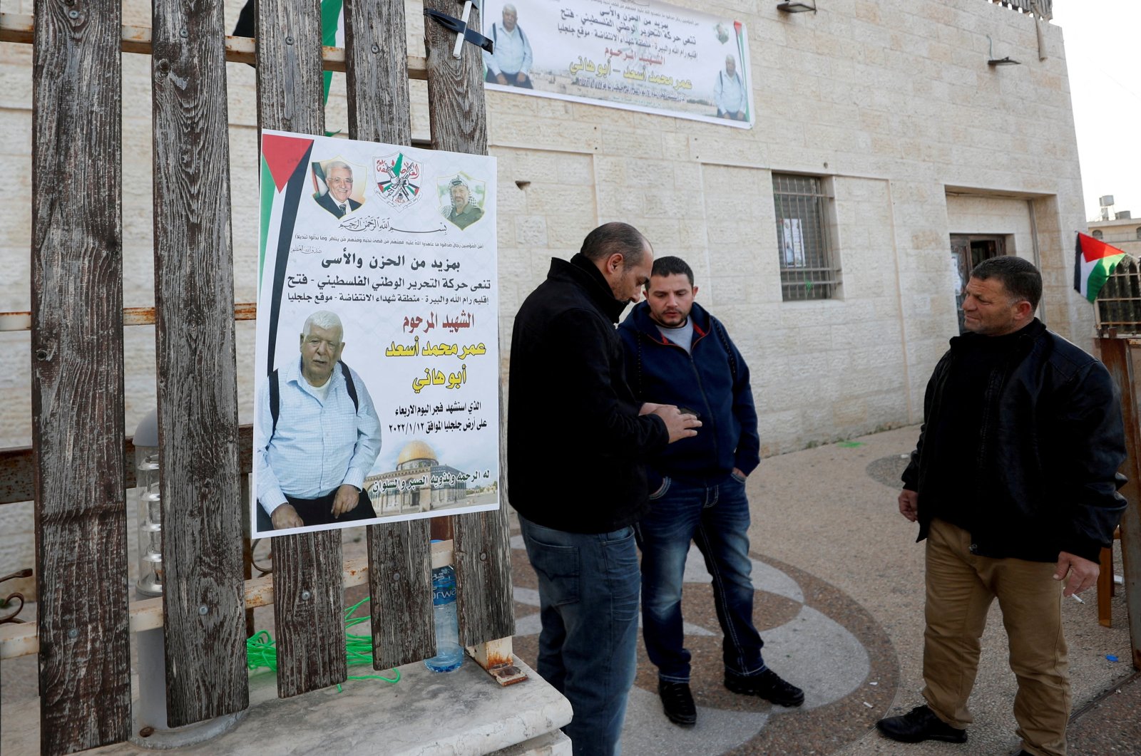Men stand next to a poster of Palestinian Omar Abdalmajeed As&#039;ad, in Jiljilya village in the Israeli-occupied West Bank, Jan. 12, 2022. (Reuters Photo)