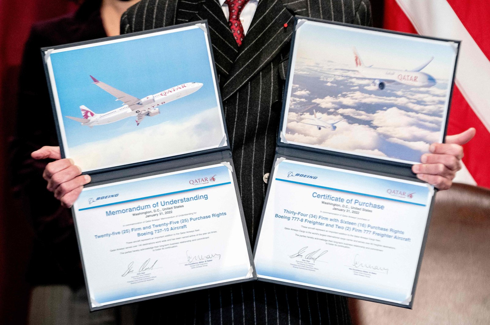 Akbar Al Baker, Group Chief Executive Officer of Qatar Airways, displays certificates following a signing ceremony in the Eisenhower Executive Office building in Washington, D.C., Jan. 31, 2022. (AFP Photo)
