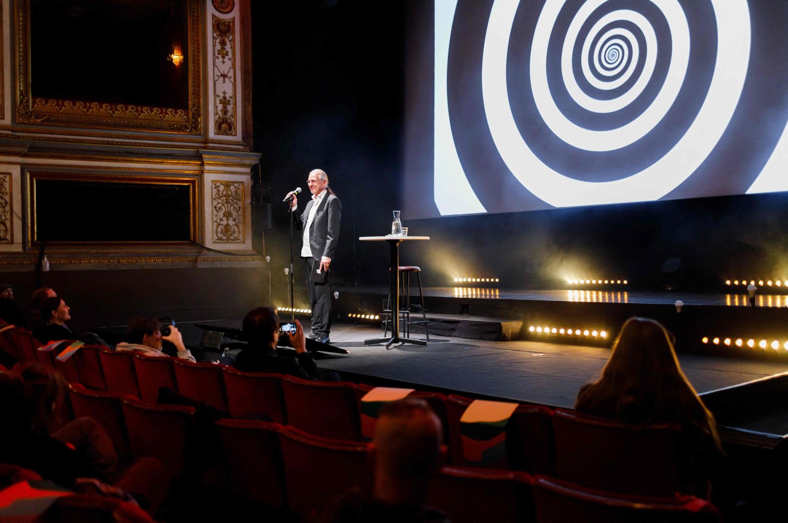 This handout photo made available by the Goteborg Film Festival shows hypnotist Fredrik Praesto addressing the audience prior to the first screening of the Hypnotic Cinema at the Stora Teatern in Gothenburg, Sweden, Jan. 30, 2022. (AFP)