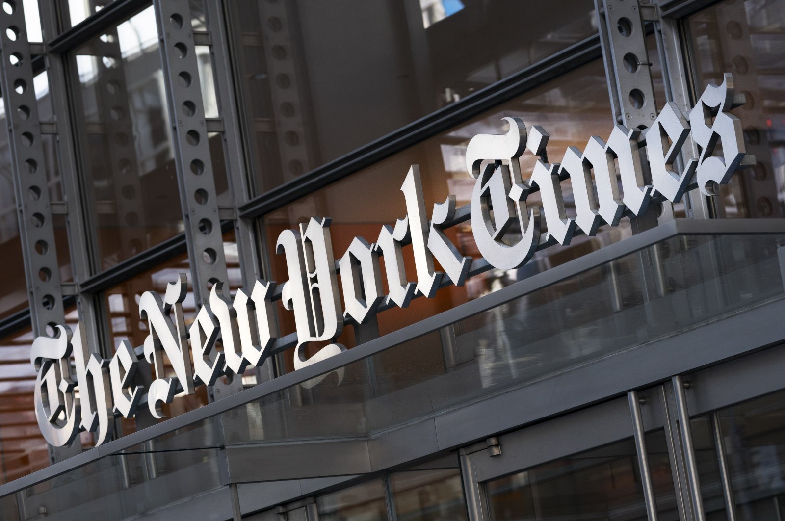 A sign for The New York Times hangs above the entrance to its building, New York City, U.S., May 6, 2021. (AP Photo)