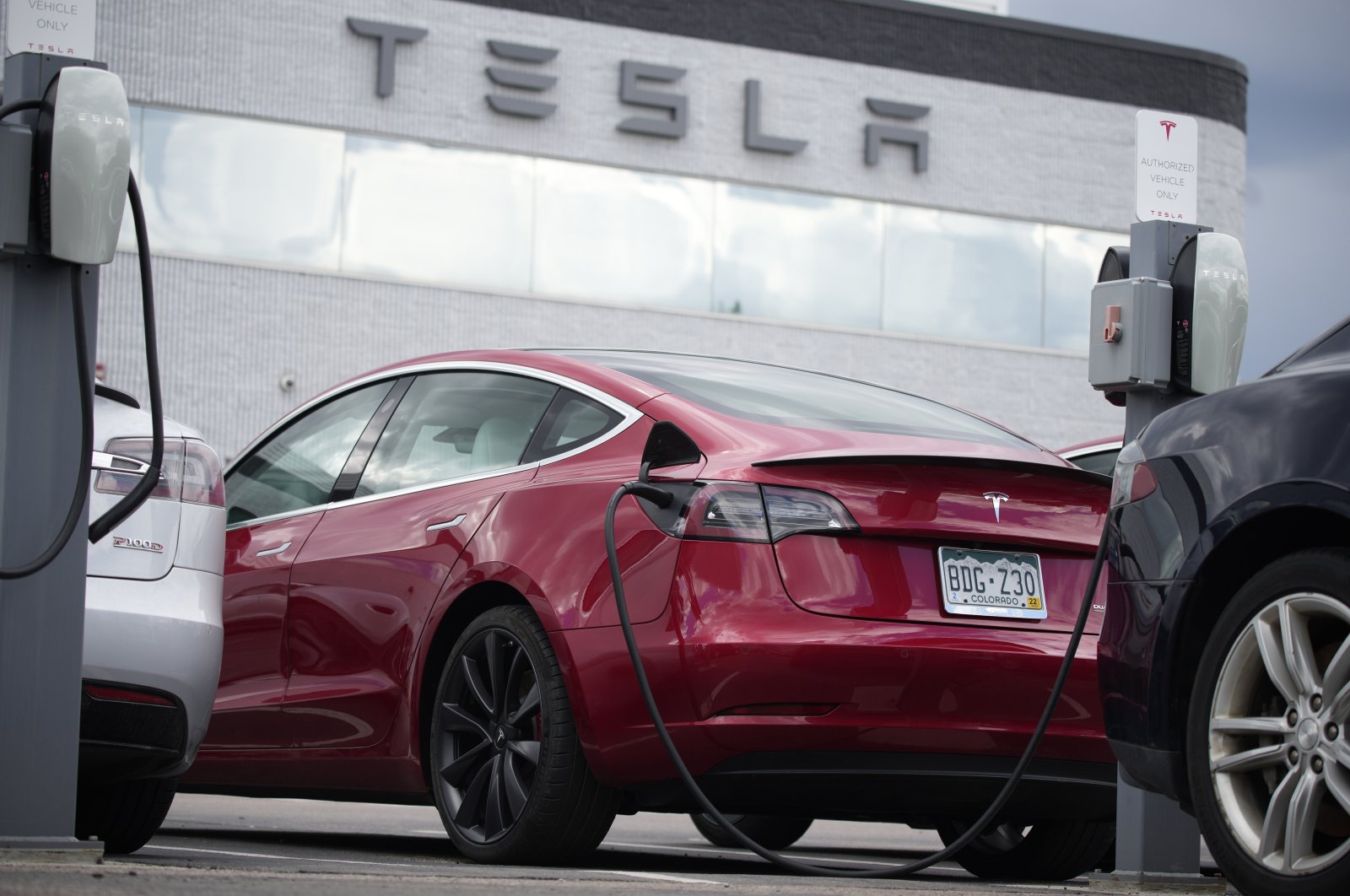 A 2021 Model 3 sedan sits in a near-empty lot at a Tesla dealership in Littleton, Colorado, U.S., June 27, 2021. (AP Photo)