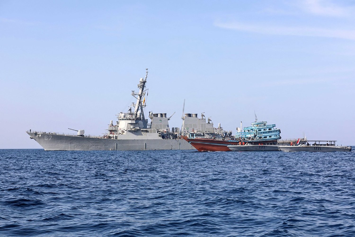 This file photo handout picture released by the U.S. Naval Forces Central Command/U.S. 5th Fleet, on Jan. 21, 2022, shows the guided-missile destroyer USS Cole (DDG 67) transferring control of a stateless fishing vessel to the Yemen Coast Guard in the Gulf of Oman. (AFP Photo)
