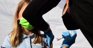 In this file photo taken on Nov. 5, 2021, a child receives a dose of Pfizer-BioNTech's COVID-19 vaccine at an event launching school vaccinations in Los Angeles, California, U.S. (AFP Photo)