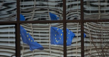 European Union flags are reflected in a window of the European Council in Brussels, Belgium, Dec. 19, 2020. (AP File Photo)
