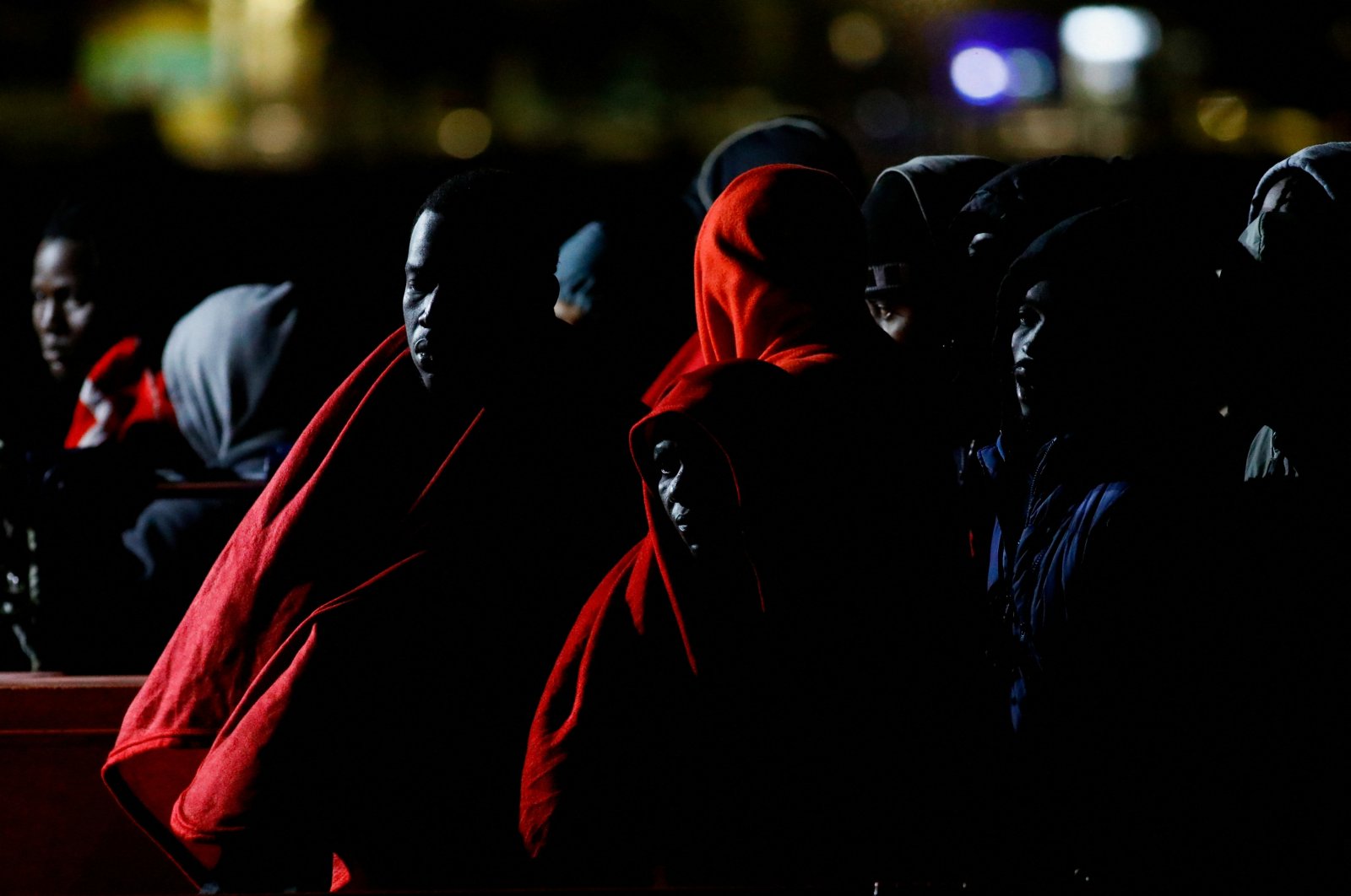 Migrants wait to disembark from a Spanish coast guard vessel at the port of Arguineguin, on the island of Gran Canaria, Spain, Jan. 26, 2022. (Reuters Photo)