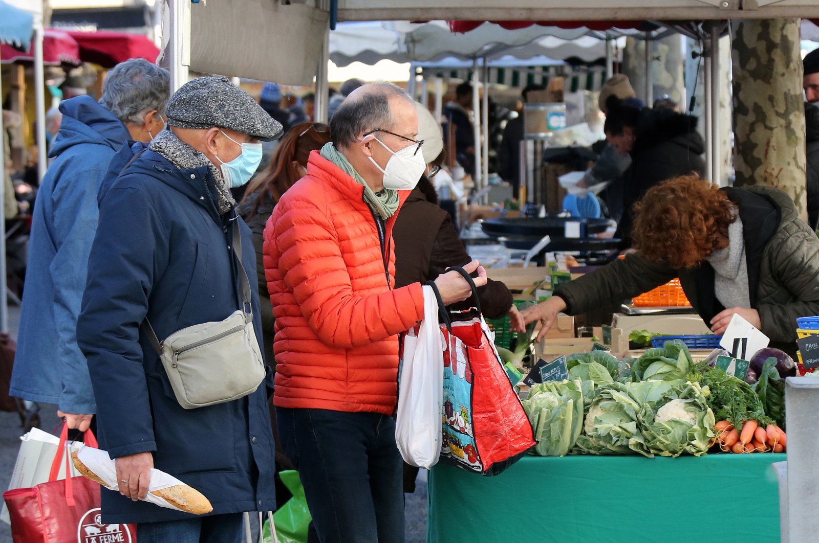 People shop at a farmers market in Saint Jean de Luz, southwestern France, Jan. 14, 2022. (AP Photo)