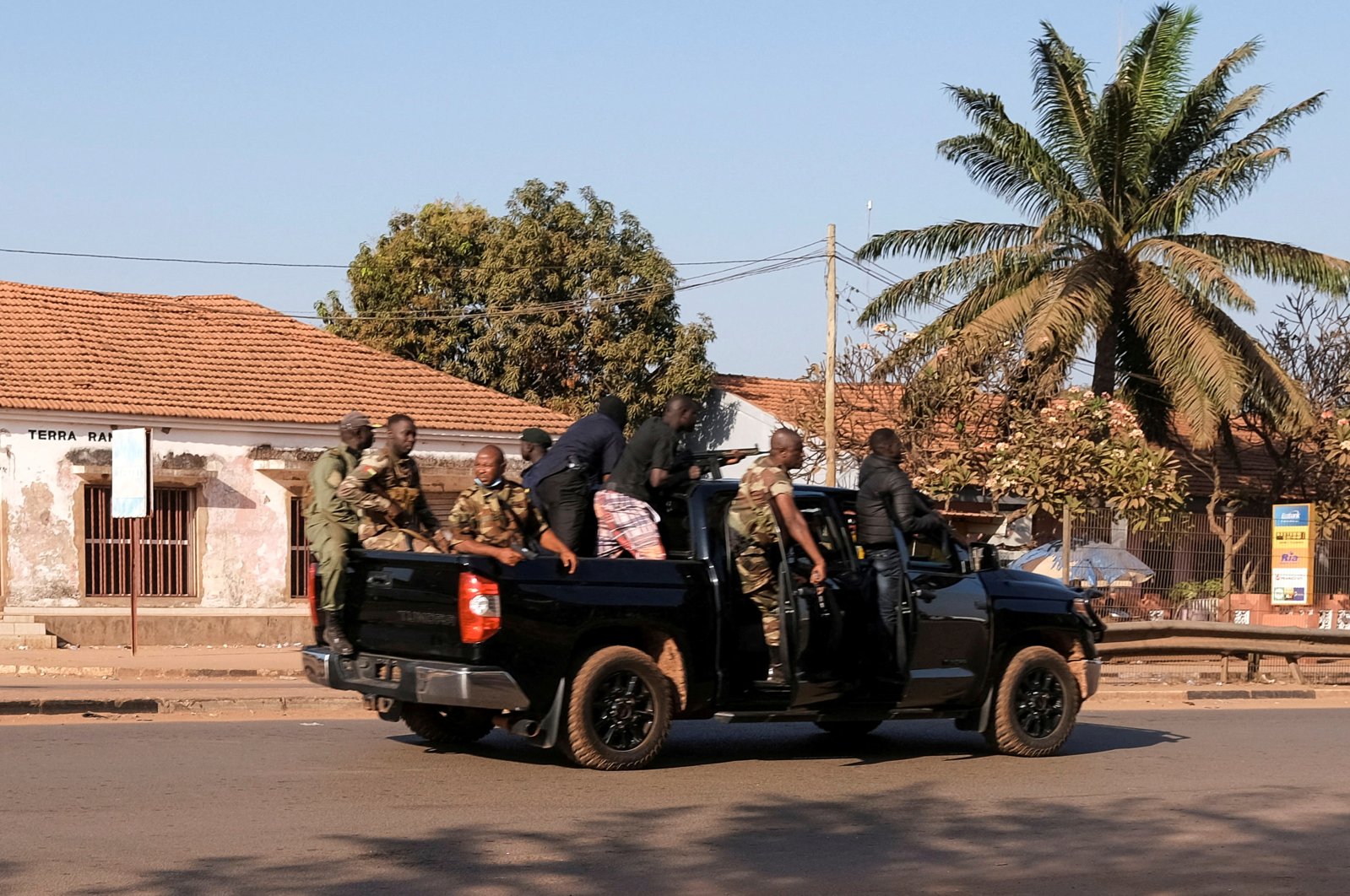 Armed soldiers move on the main artery of the capital after heavy gunfire around the presidential palace in Bissau, Guinea-Bissau Feb. 1, 2022. (Reuters Photo)