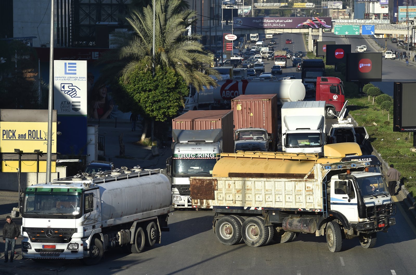 Demonstrators block the road with trucks during a protest against increased costs, gasoline prices and deteriorating living conditions, in the Dora area of northern Beirut, Lebanon, Feb. 2, 2022. (EPA Photo)