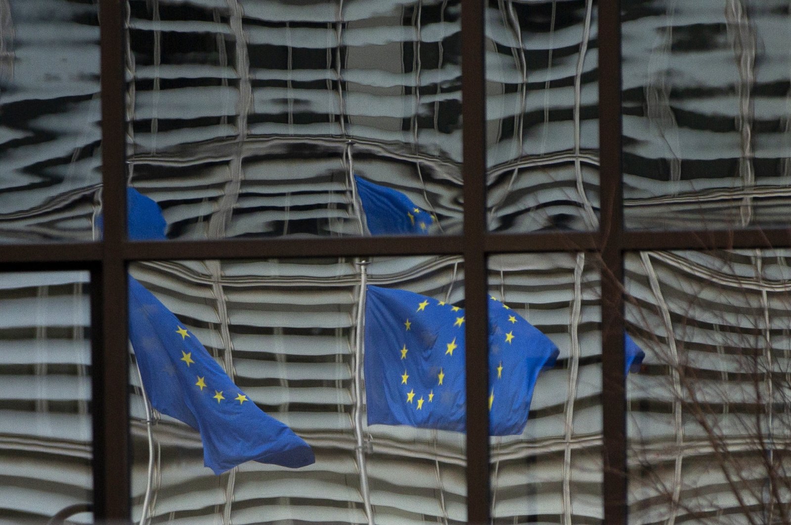 European Union flags are reflected in a window of the European Council in Brussels, Belgium, Dec. 19, 2020. (AP File Photo)
