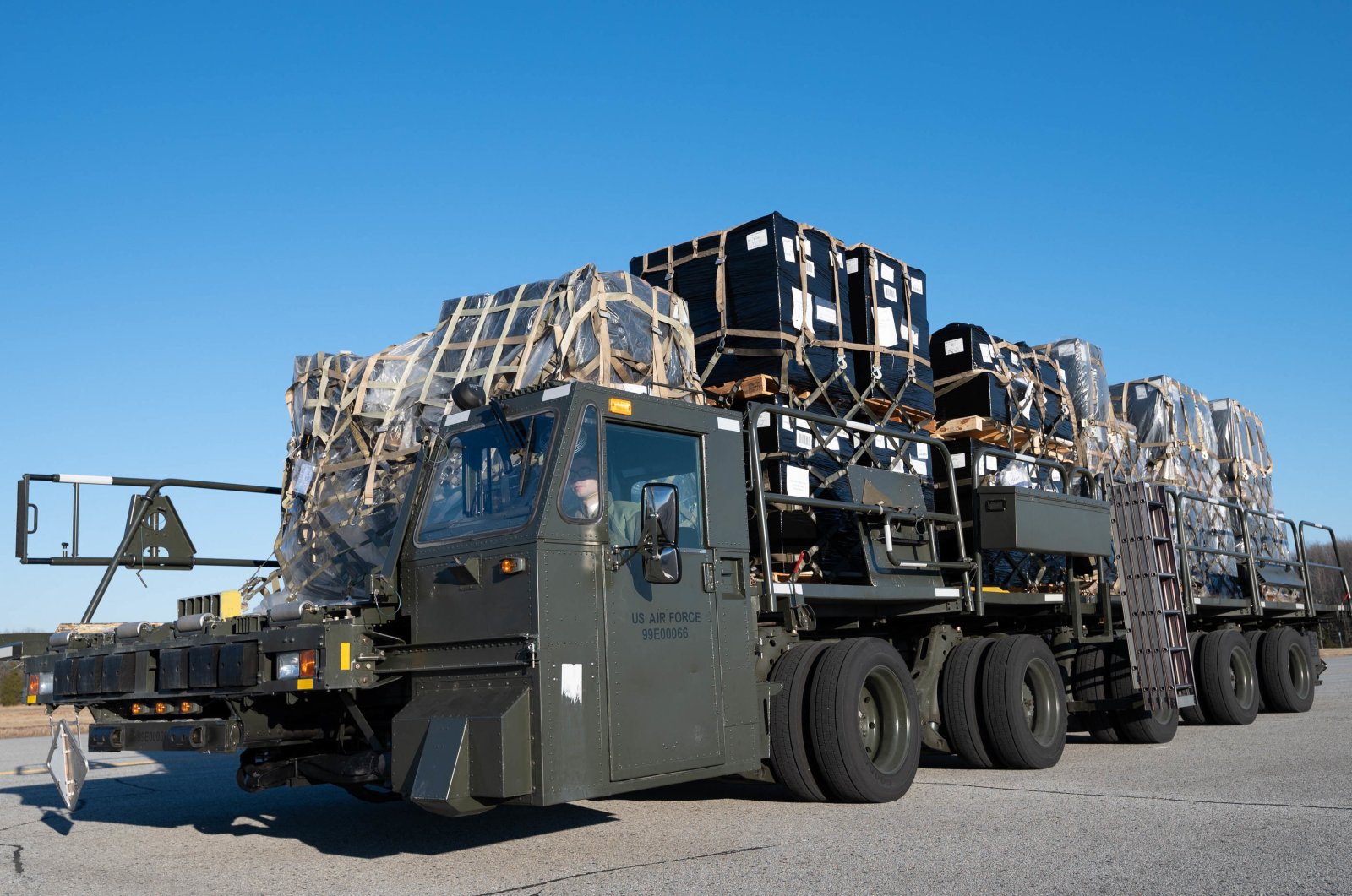 In this handout photo provided by the U.S. Air Force, airmen and civilians from the 436th Aerial Port Squadron load ammunition, weapons and other equipment bound for Ukraine during a foreign military sales mission at Dover Air Force Base, Delaware, U.S., Jan. 27, 2022. (AFP Photo/U.S. Air Force)