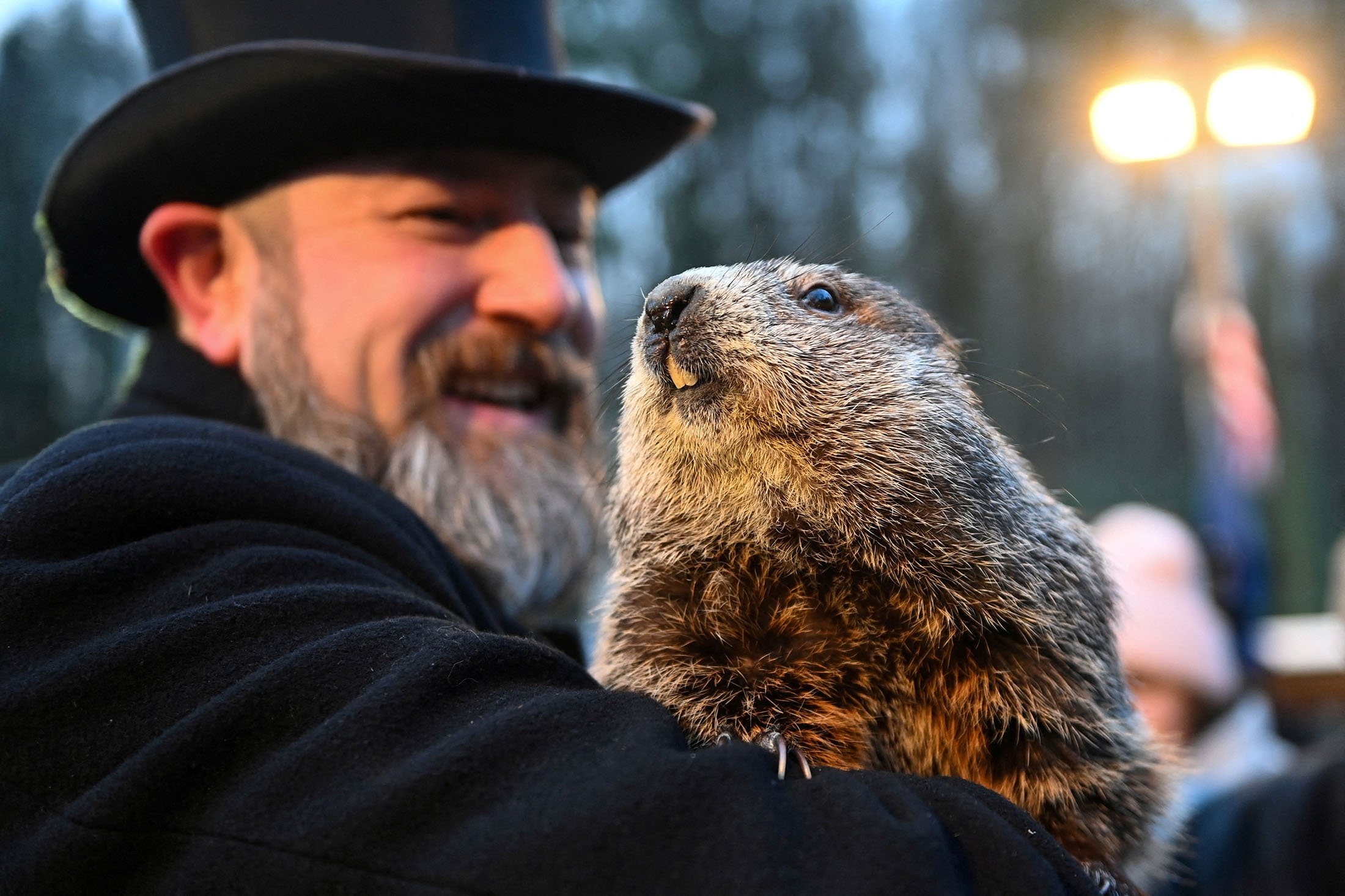 Punxsutawney Phil's handler A.J. Dereume holds the famous groundhog during the 136th Groundhog Day, at Gobblers Knob in Punxsutawney, Pennsylvania, U.S., Feb. 2, 2022. (Reuters Photo)
