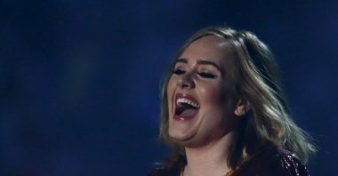 British singer Adele receives her award for British Album of the Year at the BRIT Awards at the O2 arena in London, Britain, Feb. 24, 2016. (REUTERS)