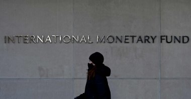 A woman walks past the International Monetary Fund headquarters in Washington, D.C., U.S., Jan. 26, 2022. (AFP Photo)