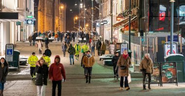 People walk along a pedestrian zone as restaurants reopen for guests, Oslo, Norway, Feb. 2, 2022 (AFP Photo)
