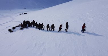 Trainees walk across a snowy slope in Van, eastern Turkey, Feb. 3, 2022. (AA PHOTO) 