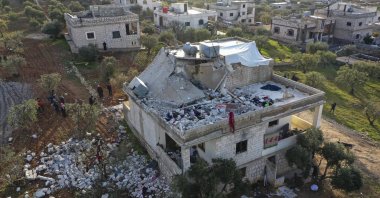 People inspect a destroyed house following an operation by the U.S. military in the Syrian village of Atmeh, in Idlib province, Syria, Feb. 3, 2022. (AP Photo)