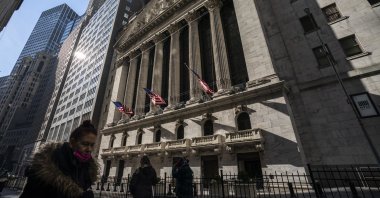 Pedestrians walk past the New York Stock Exchange, New York, U.S., Jan. 24, 2022. (AP Photo)