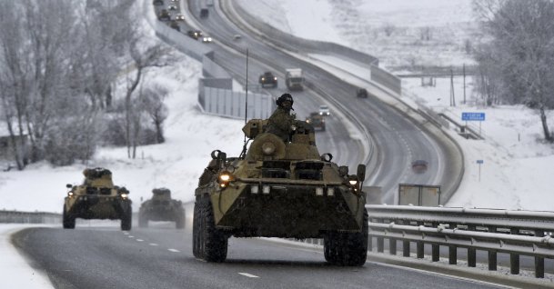 A convoy of Russian armored vehicles moves along a highway in Crimea, Ukraine, Jan. 18, 2022. (AP Photo)