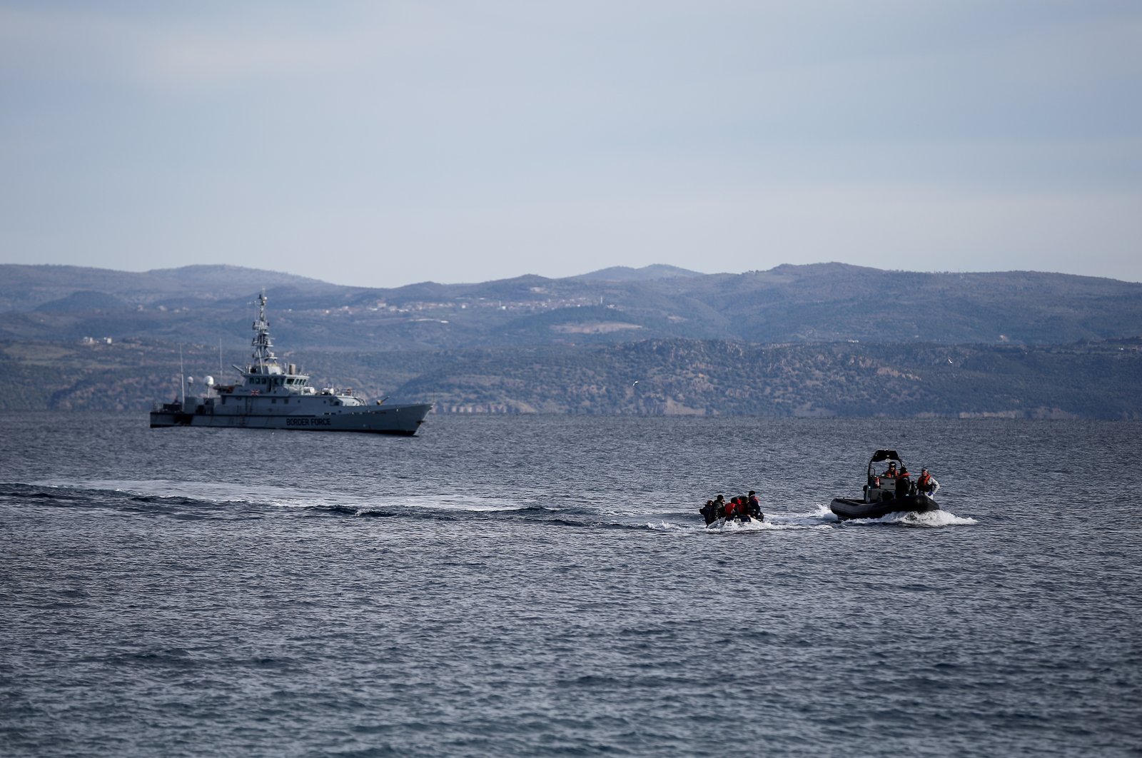 A rescue boat escorts a dinghy with migrants from Afghanistan as a Frontex vessel patrol in the background, on the island of Lesbos, Greece, Feb. 28, 2020. (Reuters File Photo)