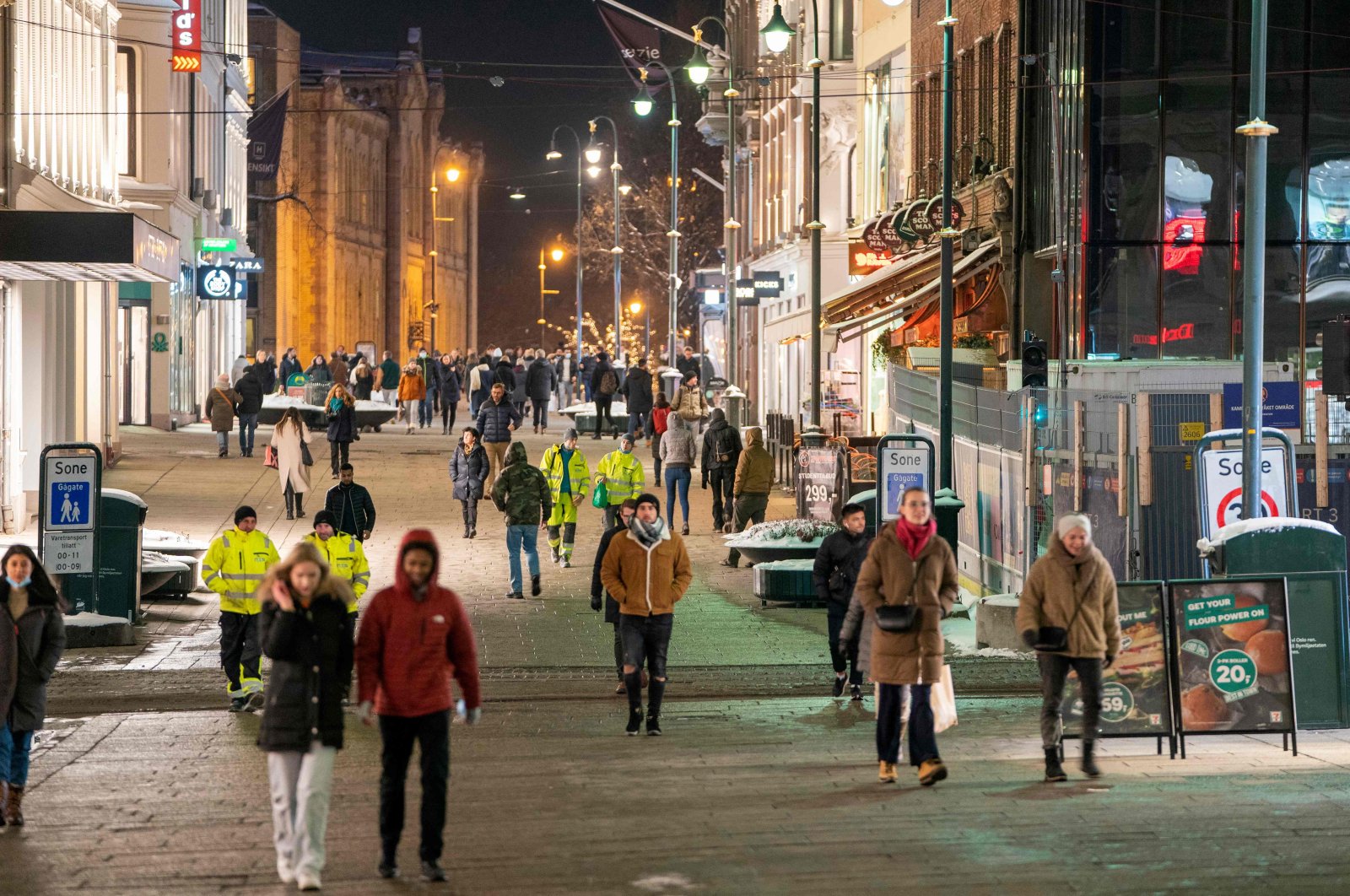 People walk along a pedestrian zone as restaurants reopen for guests, Oslo, Norway, Feb. 2, 2022 (AFP Photo)