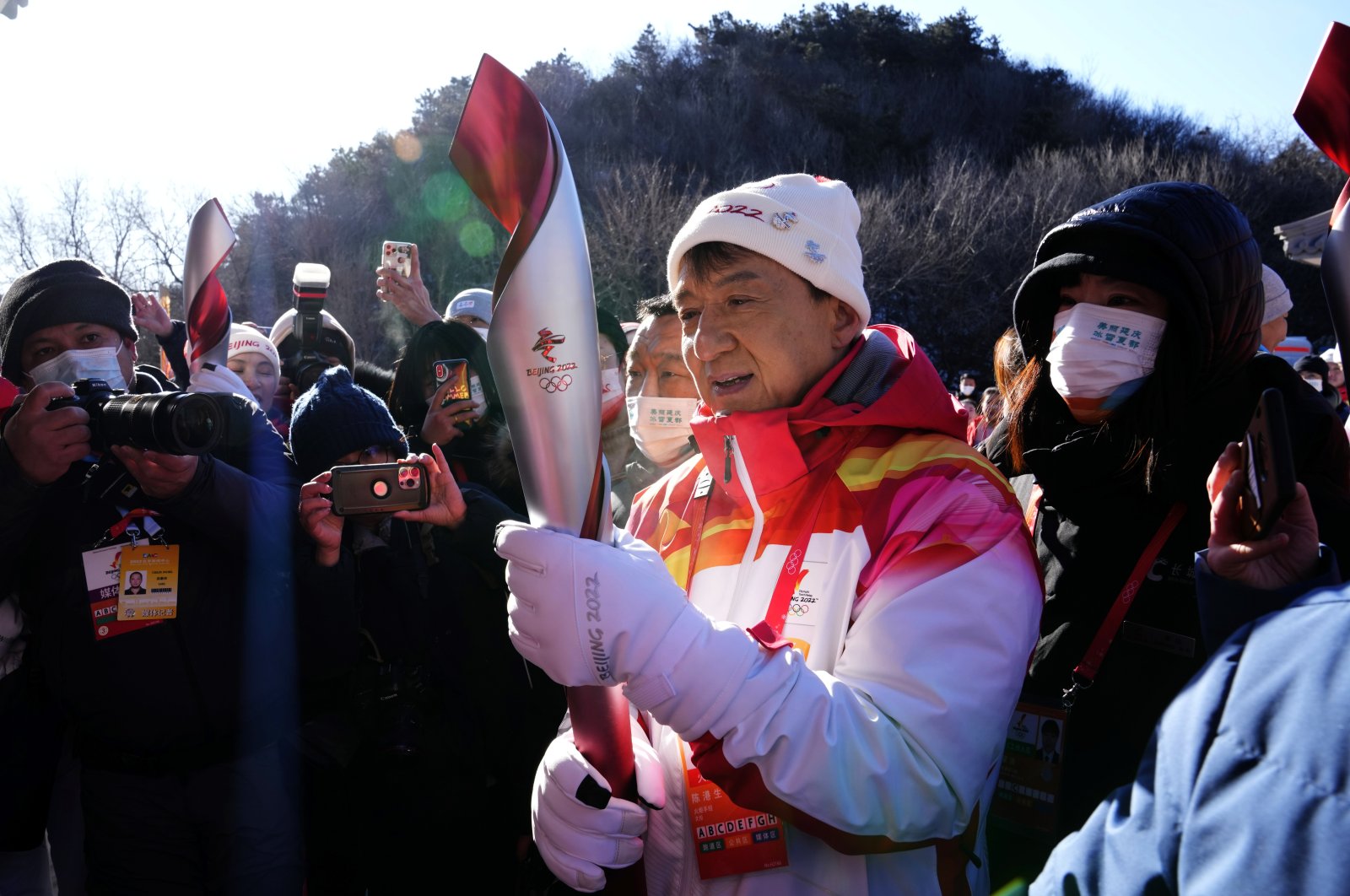 Hong Kong celebrity Jackie Chan holds the 2022 Winter Olympic torch during the torch relay at the Badaling Great Wall on the outskirts of Beijing, China, Feb. 3, 2022. (AP Photo)