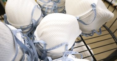 A product stall filled with free N95 respirator masks, provided by the U.S. Department of Health and Human Services, sits outside a pharmacy at a grocery store in Mississippi, U.S., Feb. 2, 2022. (AP Photo)