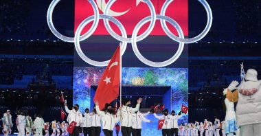 Turkey's Furkan Akar and Aysenur Duman carry the national flag into the stadium during the 2022 Winter Olympics opening ceremony, Beijing, China, Feb. 4, 2022. (AP Photo)