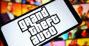 In this photo illustration, a Grand Theft Auto (GTA) logo of a computer game is seen on a smartphone screen. (Photo via Reuters)