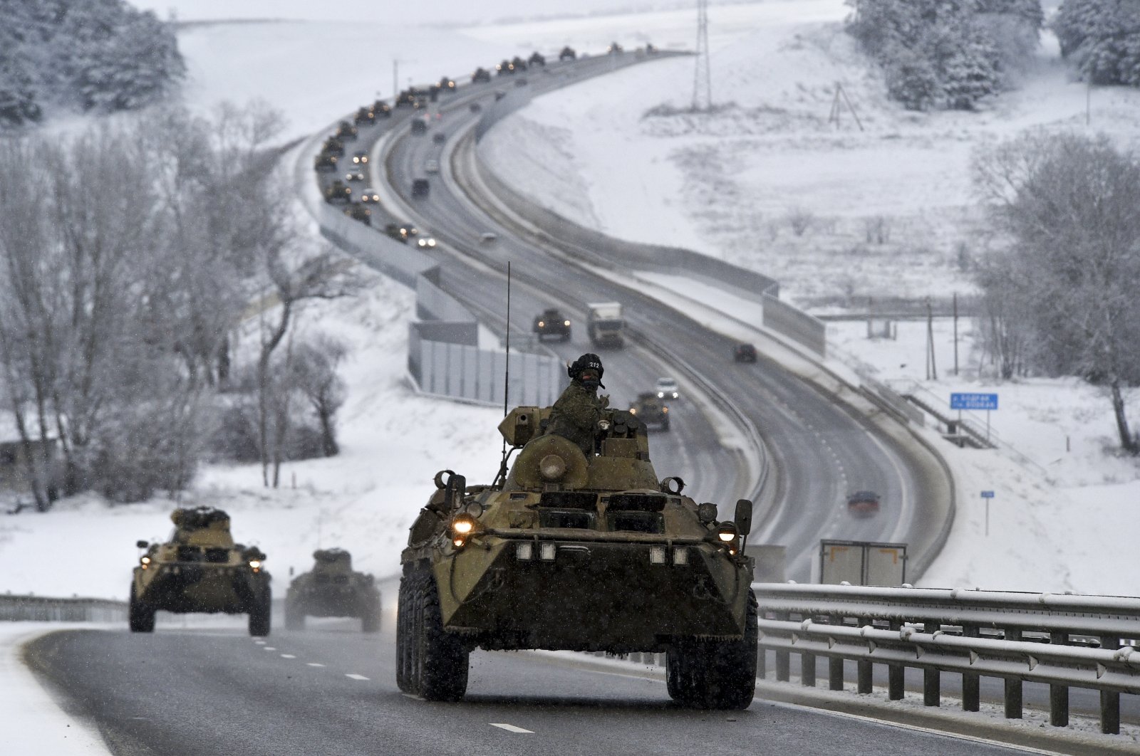  A convoy of Russian armored vehicles moves along a highway in Crimea, Tuesday, Jan. 18, 2022. A buildup of an estimated 100,000 Russian troops near Ukraine has fueled Western fears of an invasion, but Moscow has denied having plans to launch an attack while demanding security guarantees from the the U.S. and its allies. (AP Photo/File)