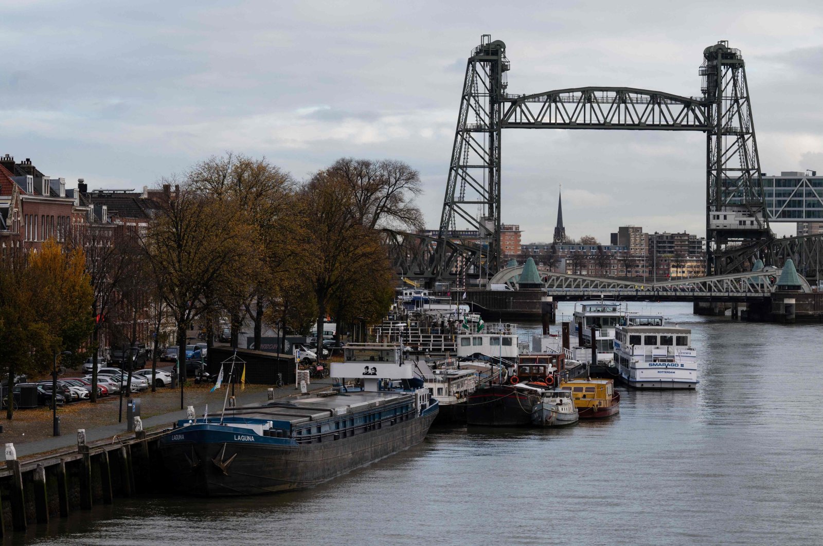 Barges docked on the Koningshaven waterway as the Koningshavenbrug "De Hef" lift bridge (R, rear) and the Koninginnebrug drawbridge (R, front) are seen in the background in Rotterdam, western Netherlands, Nov. 23, 2021.  (AFP Photo)