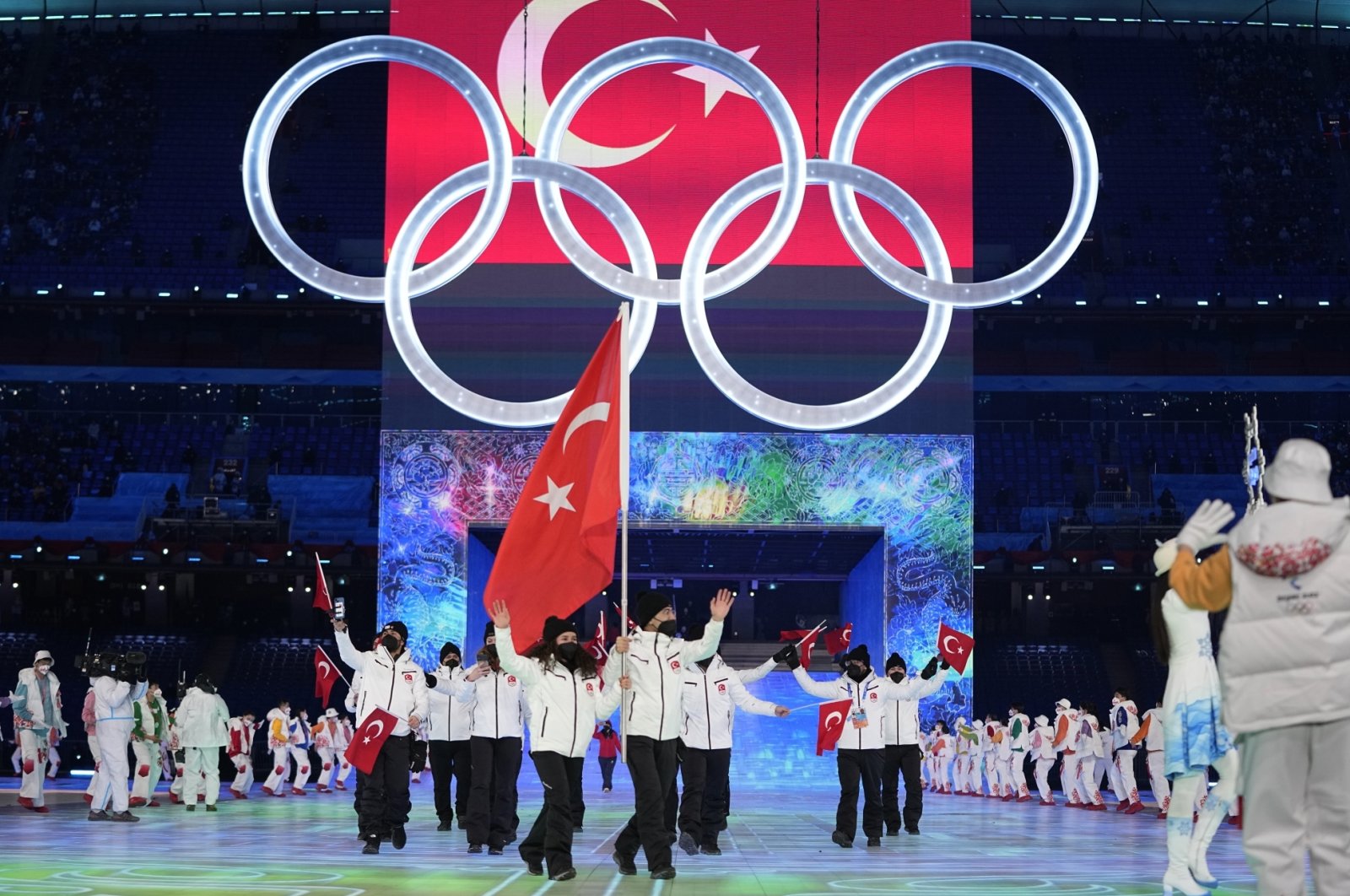 Turkey&#039;s Furkan Akar and Aysenur Duman carry the national flag into the stadium during the 2022 Winter Olympics opening ceremony, Beijing, China, Feb. 4, 2022. (AP Photo)