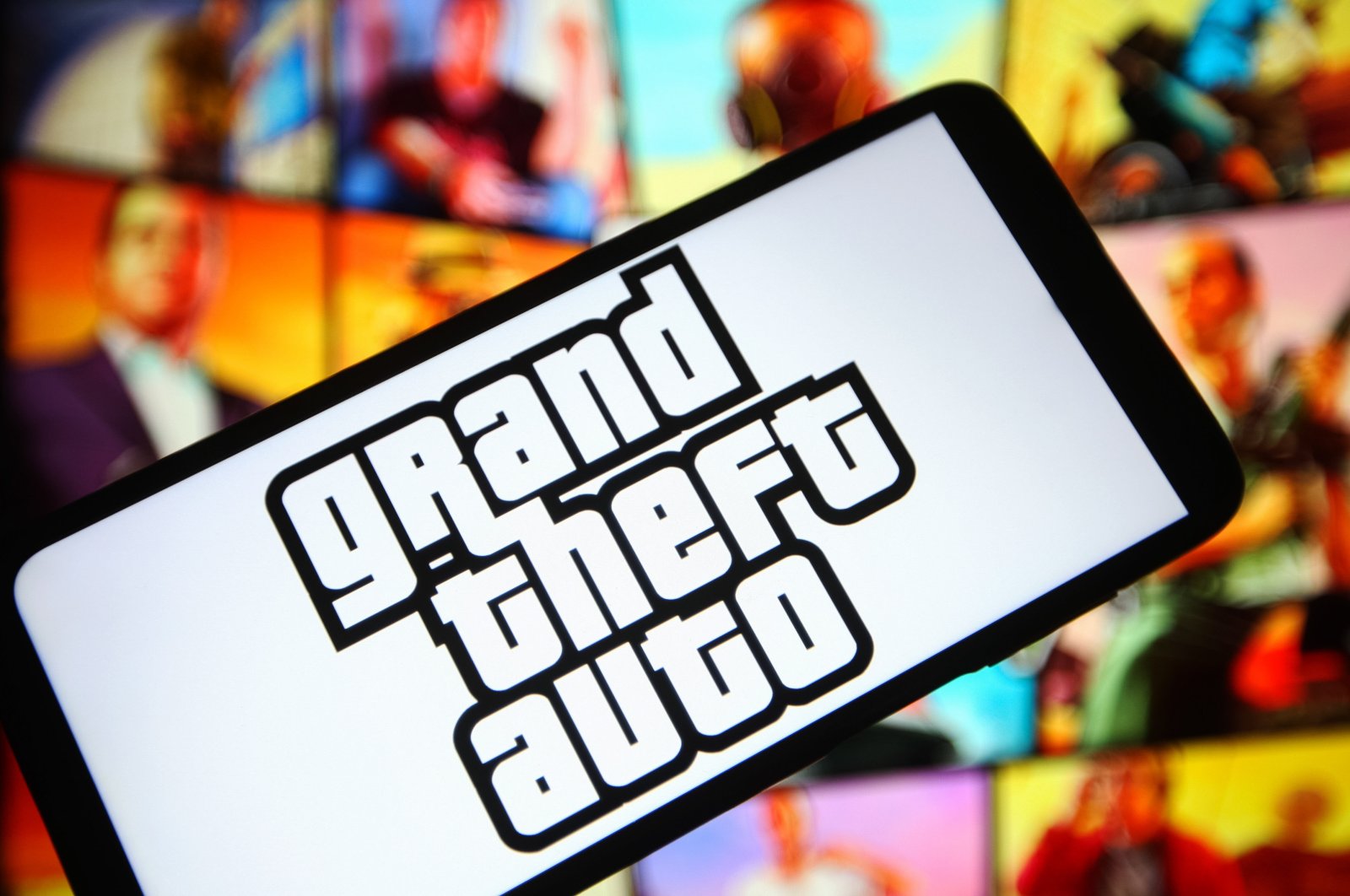 In this photo illustration, a Grand Theft Auto (GTA) logo of a computer game is seen on a smartphone screen. (Photo via Reuters)