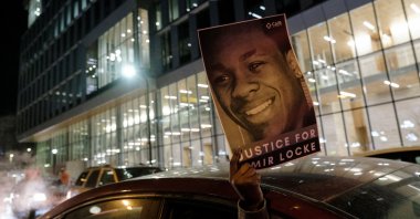 A demonstrator holds up a poster depicting Amir Locke, who was shot and killed by Minneapolis police’s SWAT team, at a protest in Minneapolis, Minnesota, U.S., Feb. 4, 2022. (Reuters Photo)