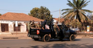 Armed soldiers move on the main artery of the capital after heavy gunfire around the presidential palace in Bissau, Guinea, Feb. 1, 2022. (Reuters Photo)