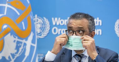 Tedros Adhanom Ghebreyesus, Director-General of the World Health Organization (WHO), removes his protective face mask prior to speaking to the media regarding the coronavirus and WHO's global health priorities in 2022, during a new press conference, at WHO headquarters in Geneva, Switzerland, Dec. 20, 2021. (AP Photo)
