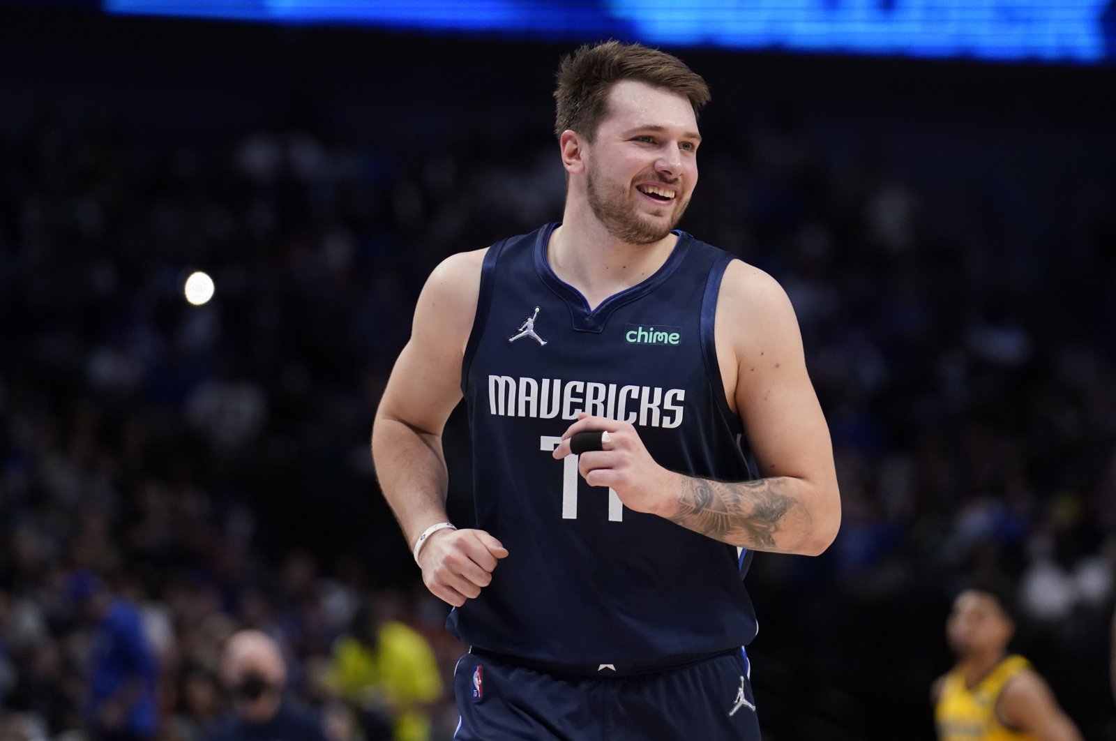 Dallas Mavericks guard Luka Doncic (77) smiles as he jogs up court after sinking a basket in the second half of an NBA basketball game against the Indiana Pacers in Dallas, U.S., Jan. 29, 2022. (AP Photo)