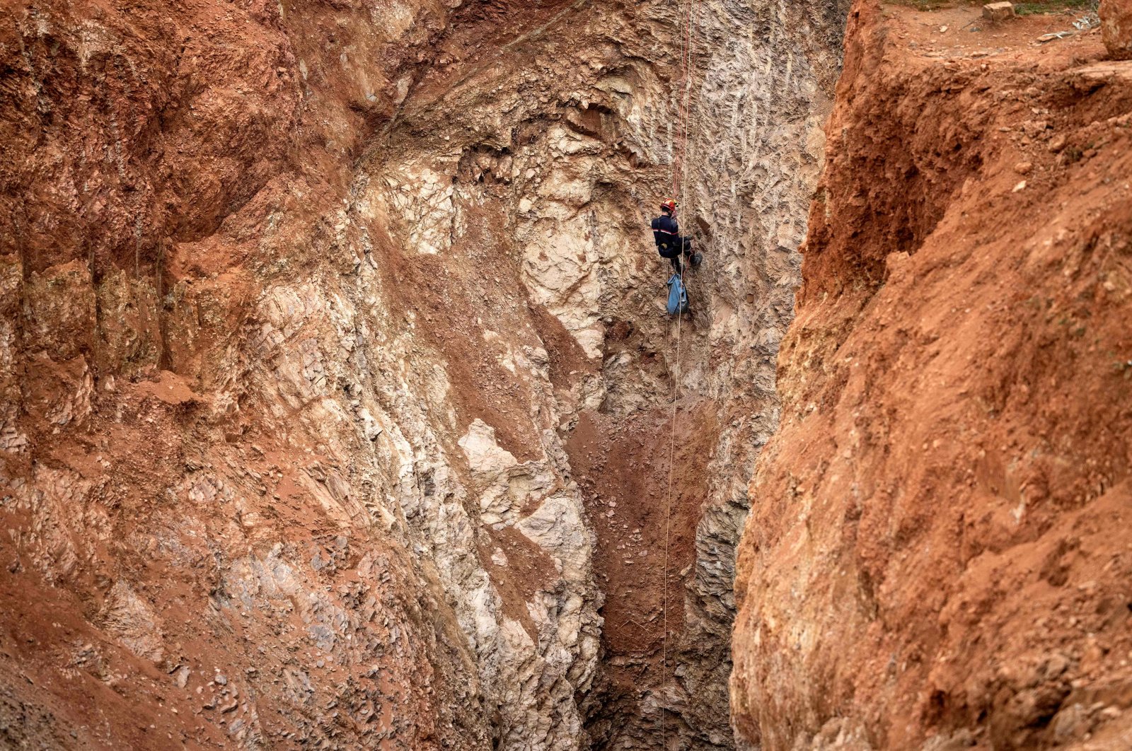 A Moroccan emergency services climber works to rescue a 5-year-old boy, Rayan, who fell into a well on Feb. 1, in the remote village of Ighrane in the rural northern province of Chefchaouen, Morocco, Feb. 4, 2022. (AFP Photo)