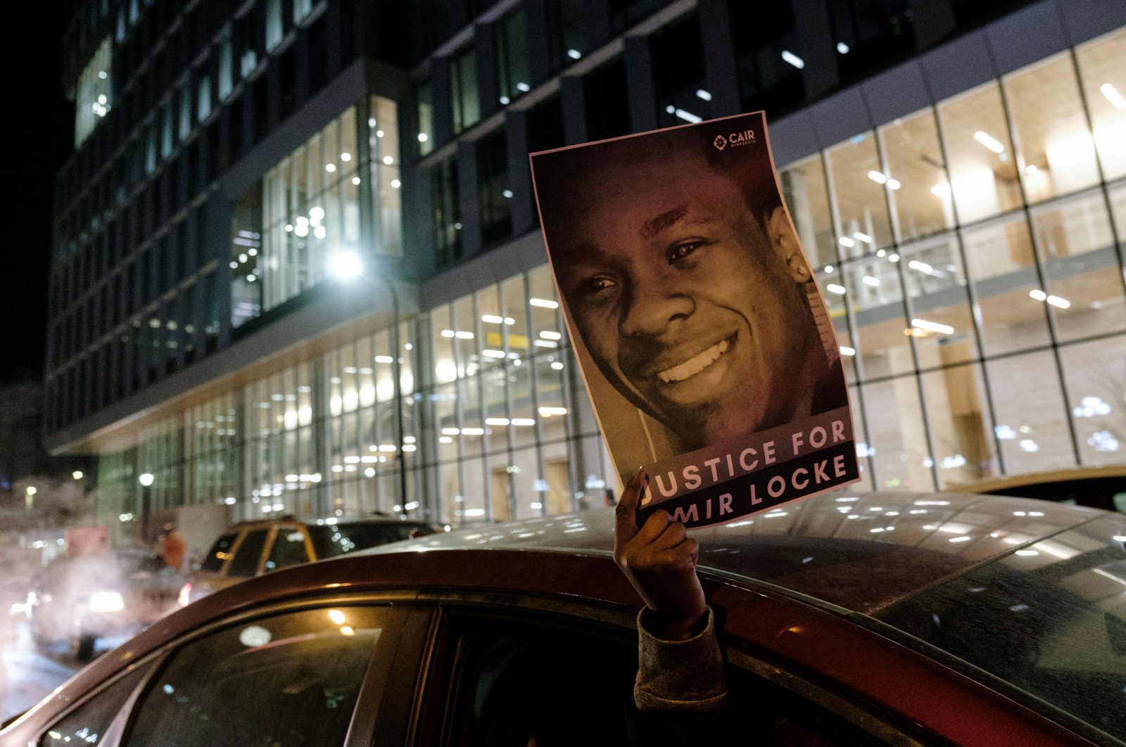A demonstrator holds up a poster depicting Amir Locke, who was shot and killed by Minneapolis police’s SWAT team, at a protest in Minneapolis, Minnesota, U.S., Feb. 4, 2022. (Reuters Photo)