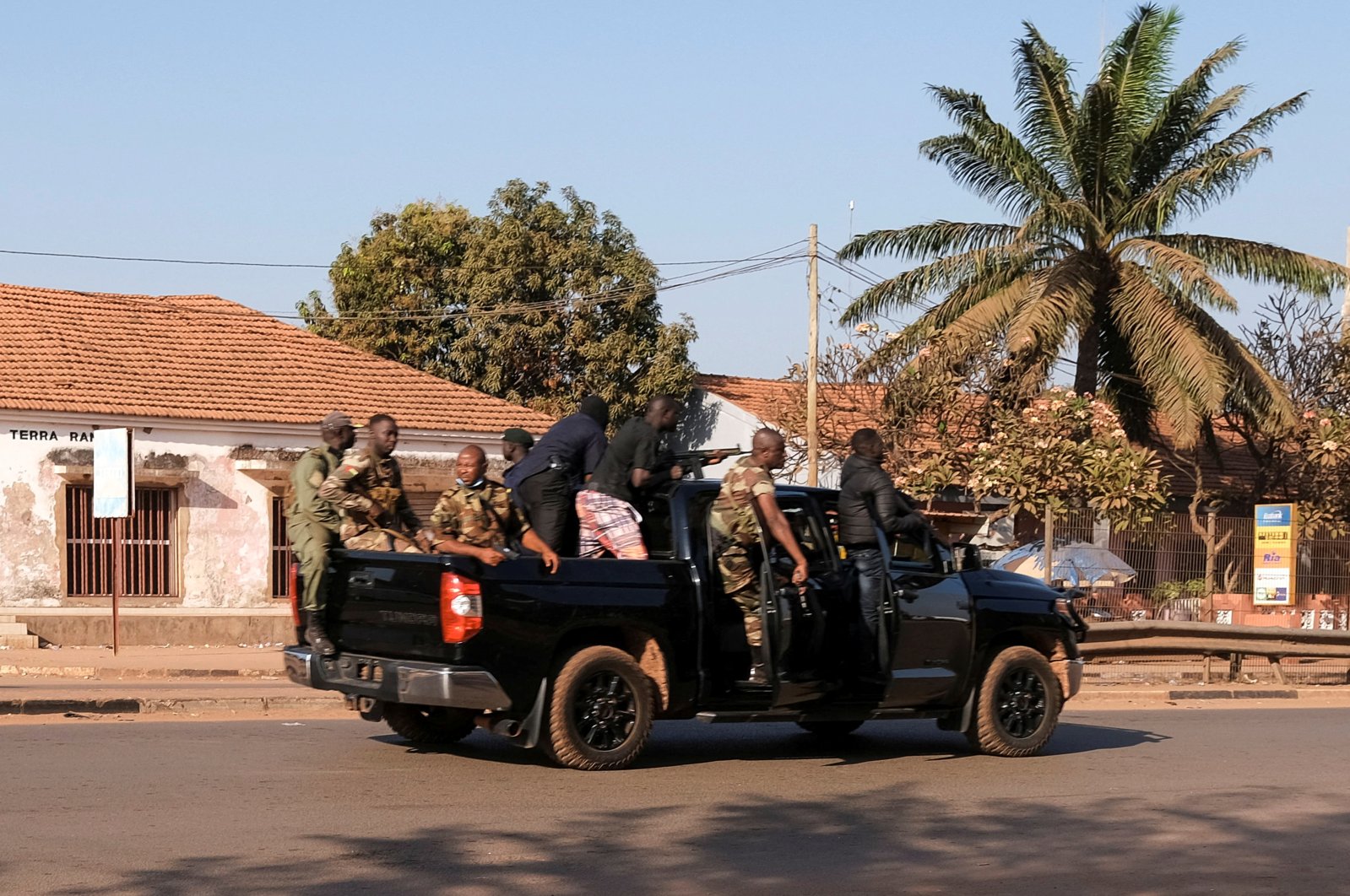 Armed soldiers move on the main artery of the capital after heavy gunfire around the presidential palace in Bissau, Guinea, Feb. 1, 2022. (Reuters Photo)
