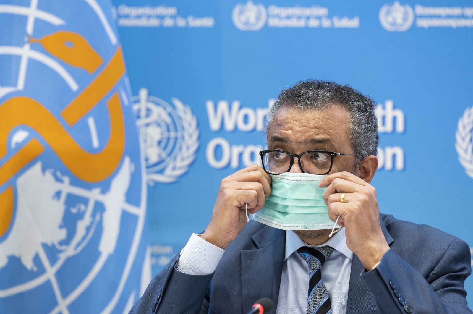 Tedros Adhanom Ghebreyesus, Director-General of the World Health Organization (WHO), removes his protective face mask prior to speaking to the media regarding the coronavirus and WHO&#039;s global health priorities in 2022, during a new press conference, at WHO headquarters in Geneva, Switzerland, Dec. 20, 2021. (AP Photo)