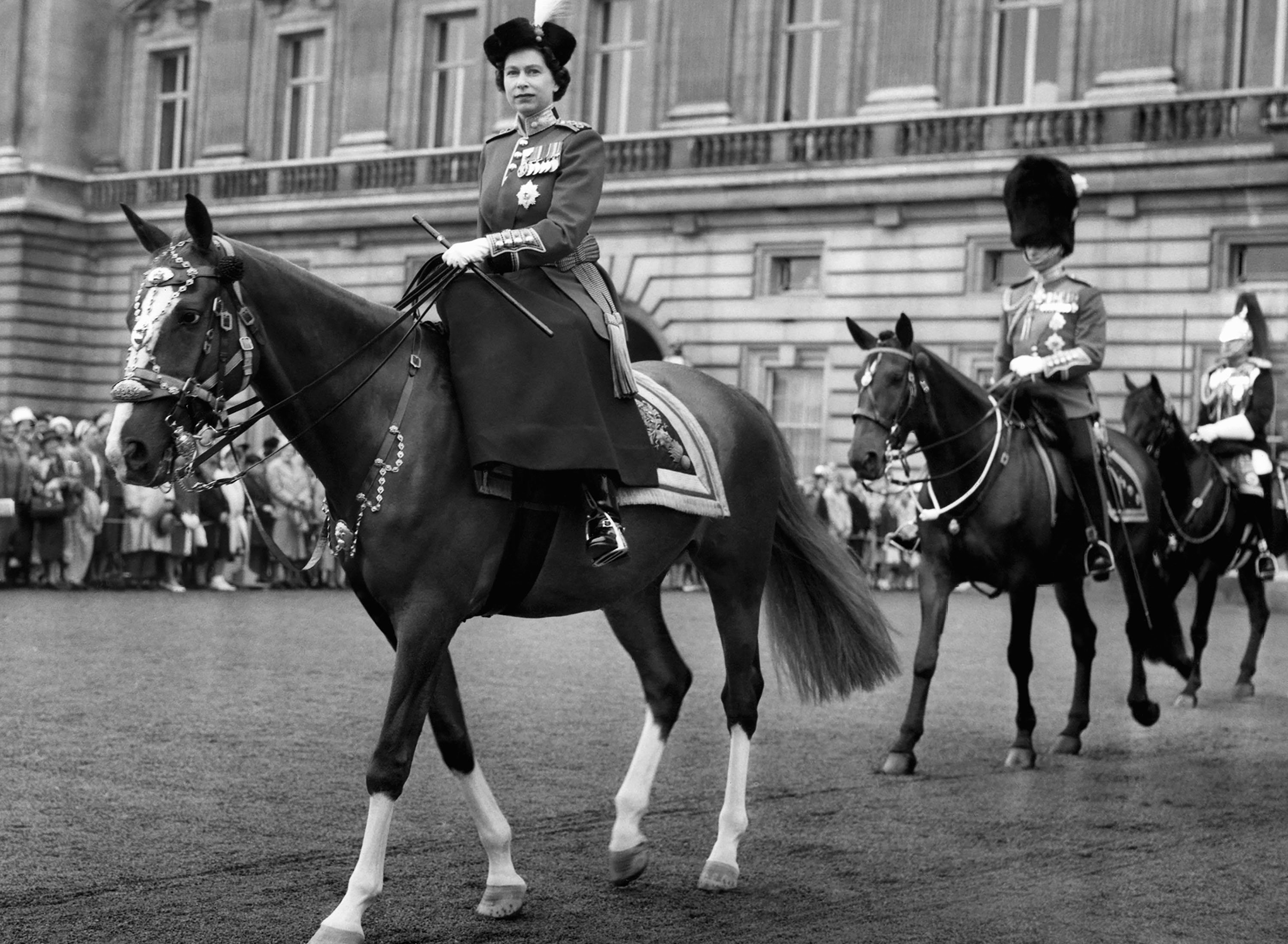 Queen Elizabeth II, rides out from Buckingham Palace to take the salute at the ceremony of Trooping the Colour, followed by Prince Philip and the Duke of Gloucester, the Queen's uncle, in London, U.K., June 15, 1960. (AP Photo)