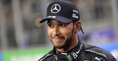 Mercedes driver Lewis Hamilton of Britain smiles after winning the pole position during qualifying for the Formula One Saudi Arabian Grand Prix auto race in Jeddah, Saudi Arabia, Dec. 4, 2021. (AP Photo)