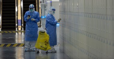Health workers in PPE suits take random samples for COVID-19 at the Beijing 2022 Olympic Games Main Media Centre, Beijing, China, Feb. 5, 2022. (EPA Photo)