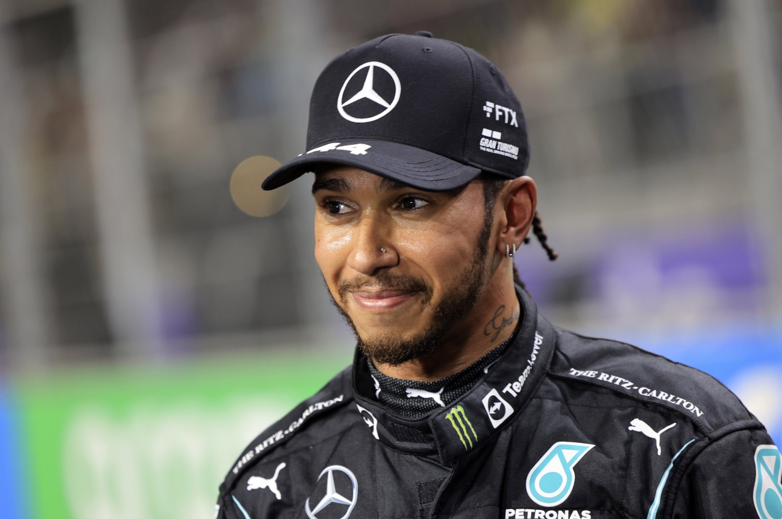Mercedes driver Lewis Hamilton of Britain smiles after winning the pole position during qualifying for the Formula One Saudi Arabian Grand Prix auto race in Jeddah, Saudi Arabia, Dec. 4, 2021. (AP Photo)
